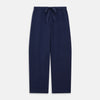 View 6 of product The Women's Harriet Navy Silk Pyjama Set by Turnbull & Asser features a long-sleeve, button-up top with white piping and chest pocket, plus matching drawstring pants—luxurious sleepwear displayed on a white background.