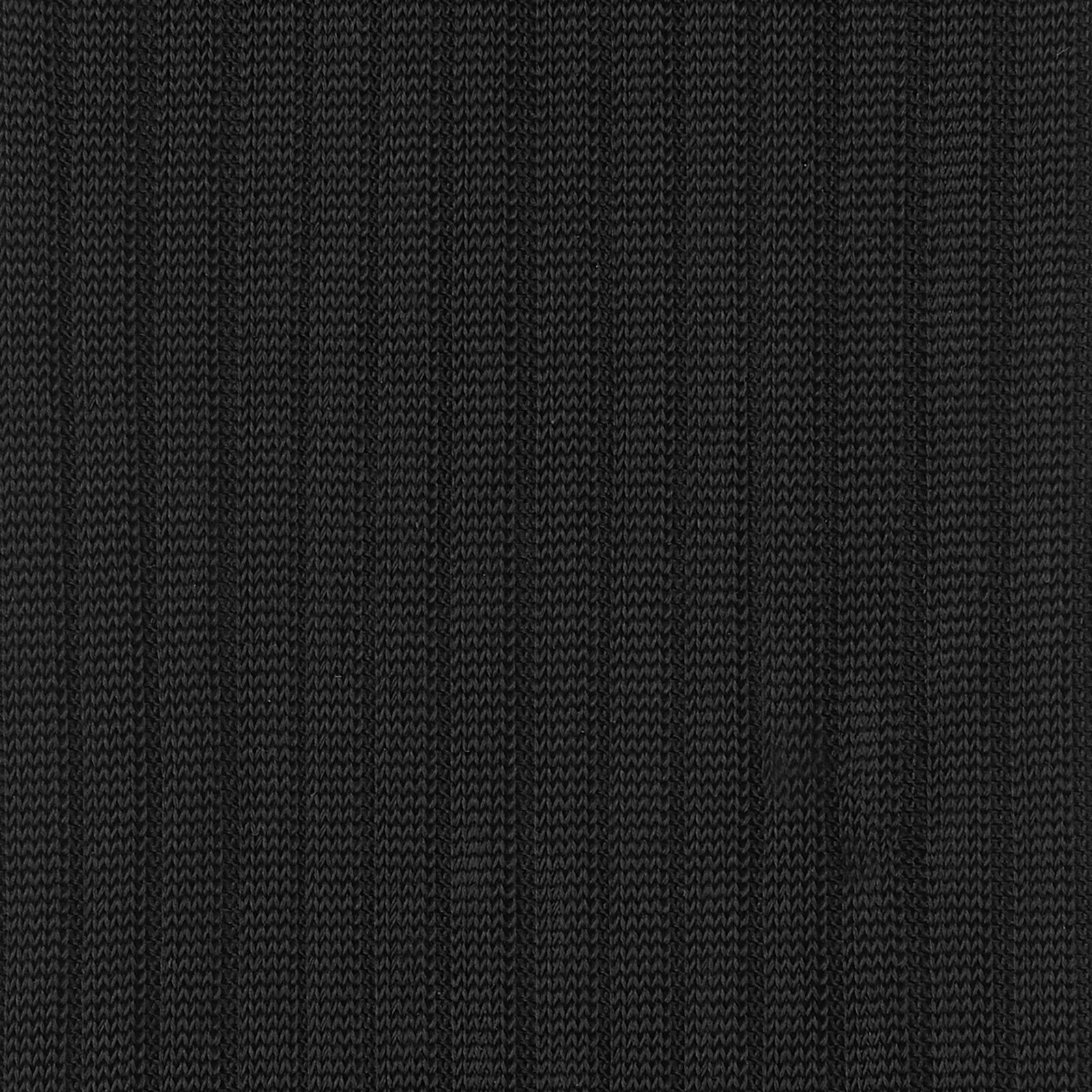 View 2 of product A single Black Long Silk Sock by Turnbull & Asser from our luxury men's collection is shown in side profile on a plain white background, with the foot pointing down and the cuff angled left.