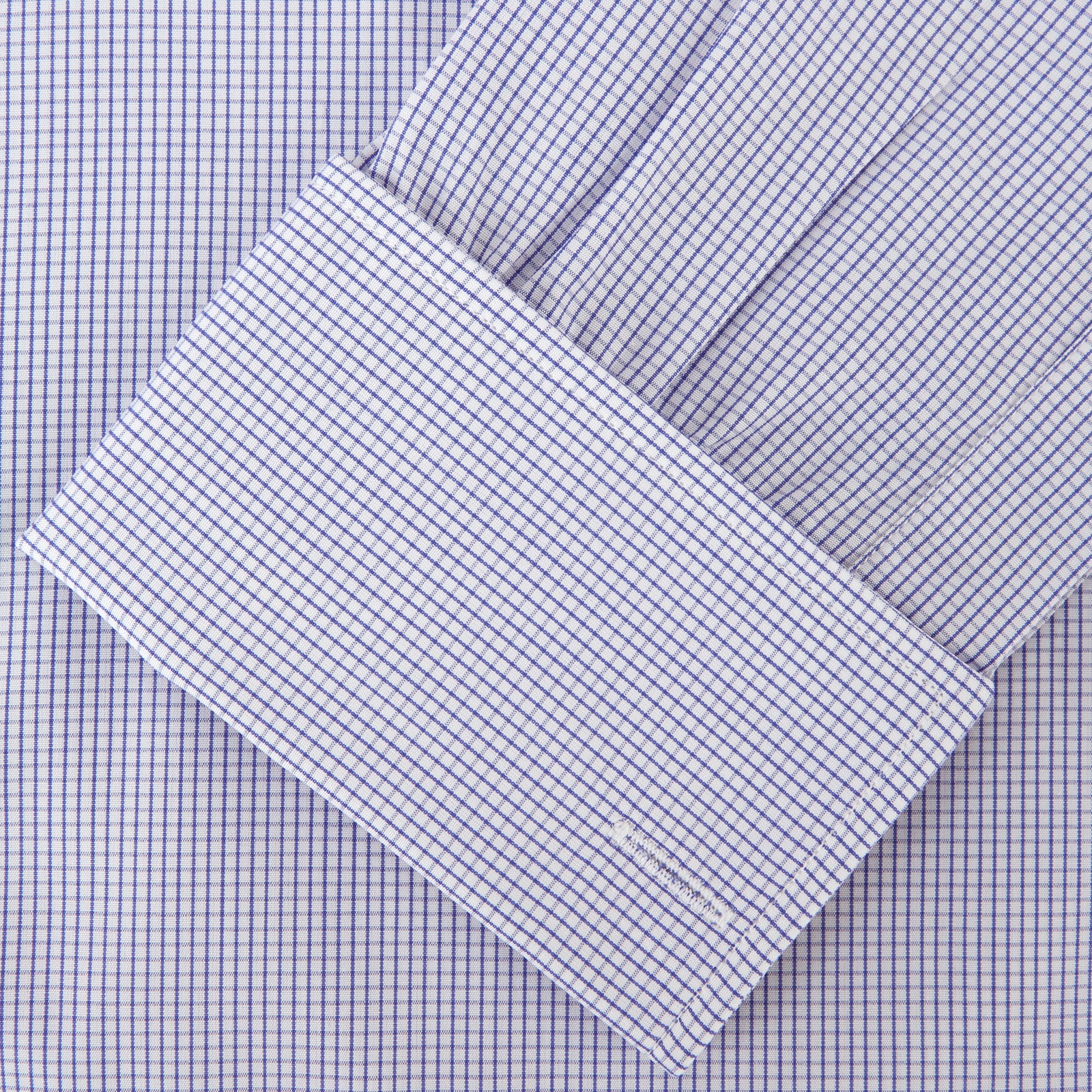 View 3 of product The Blue Grid Check Shirt by Turnbull & Asser features a T&A collar and double cuffs. This cotton long-sleeve shirt has an ultra-fine blue and white grid pattern and is displayed flat on a white background.