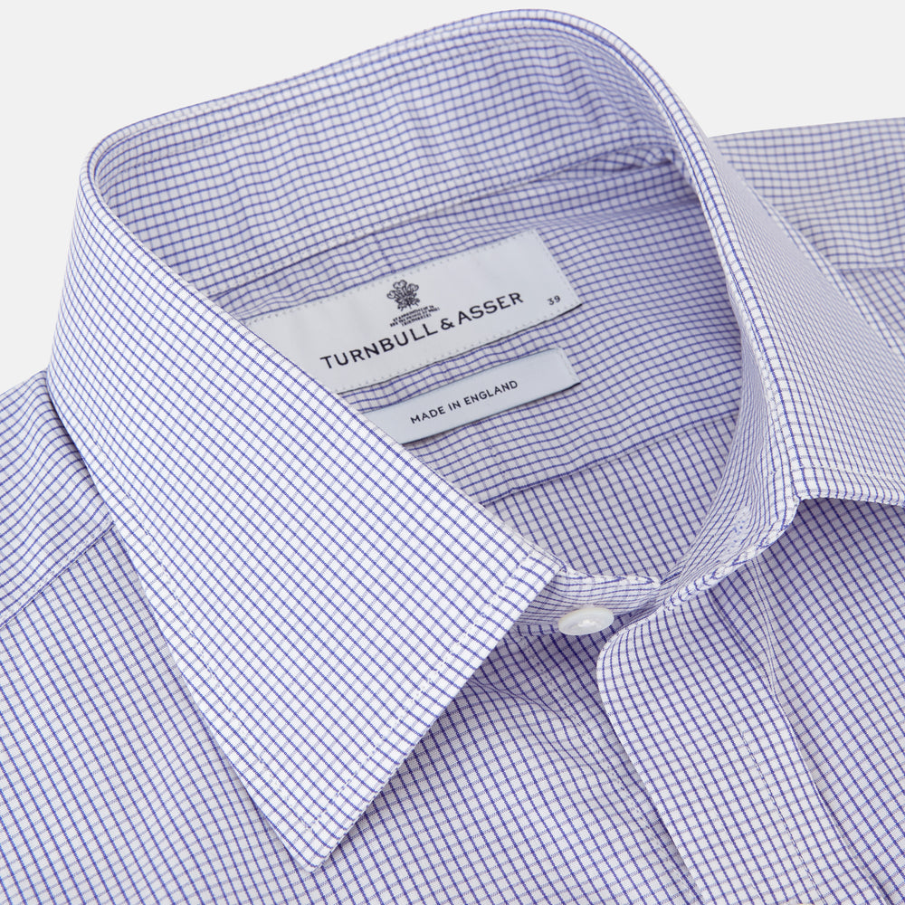 The Blue Grid Check Shirt by Turnbull & Asser features a T&A collar and double cuffs. This cotton long-sleeve shirt has an ultra-fine blue and white grid pattern and is displayed flat on a white background.