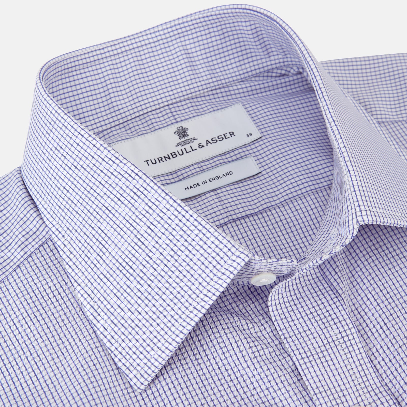 View 2 of product The Blue Grid Check Shirt by Turnbull & Asser features a T&A collar and double cuffs. This cotton long-sleeve shirt has an ultra-fine blue and white grid pattern and is displayed flat on a white background.