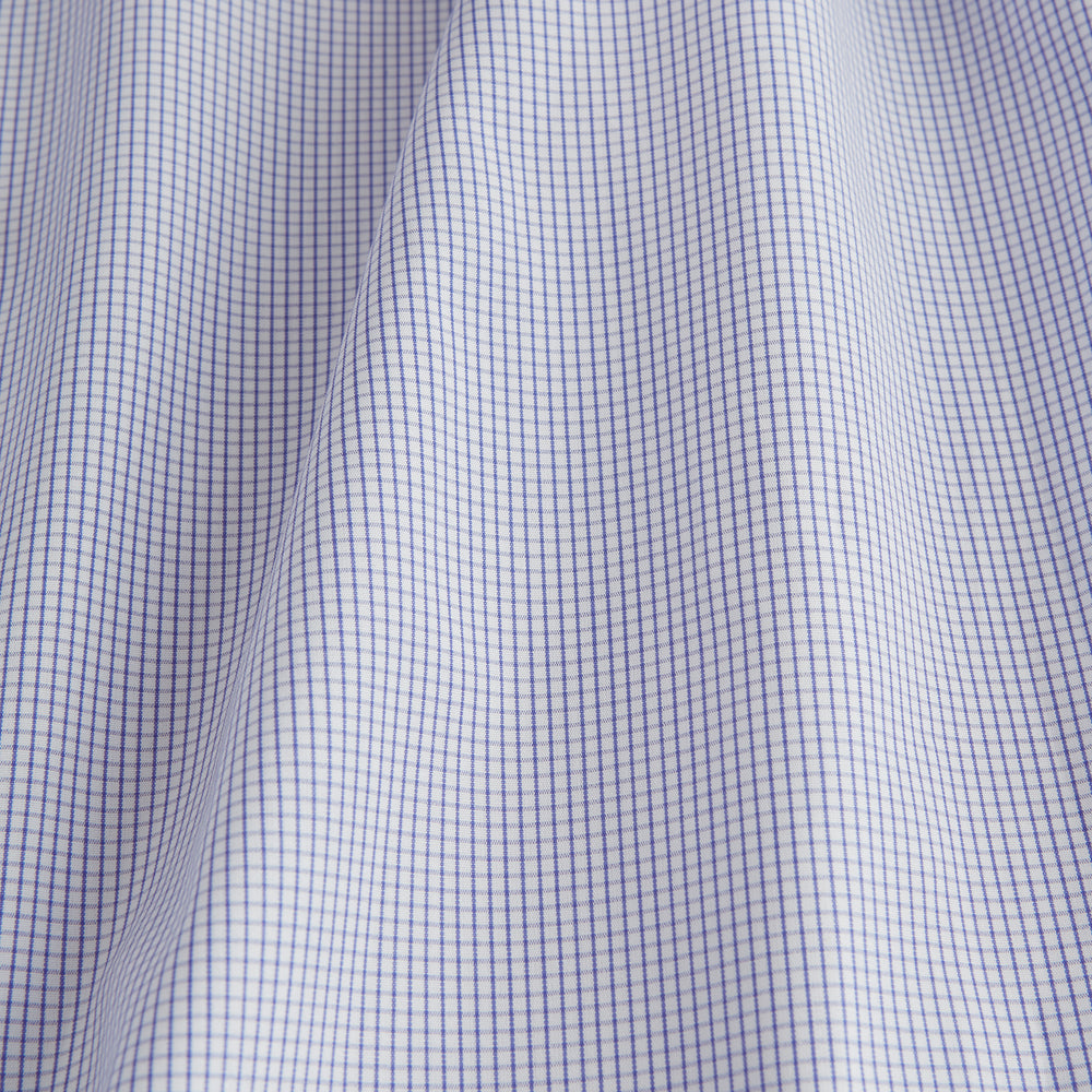 The Blue Grid Check Shirt by Turnbull & Asser features a T&A collar and double cuffs. This cotton long-sleeve shirt has an ultra-fine blue and white grid pattern and is displayed flat on a white background.