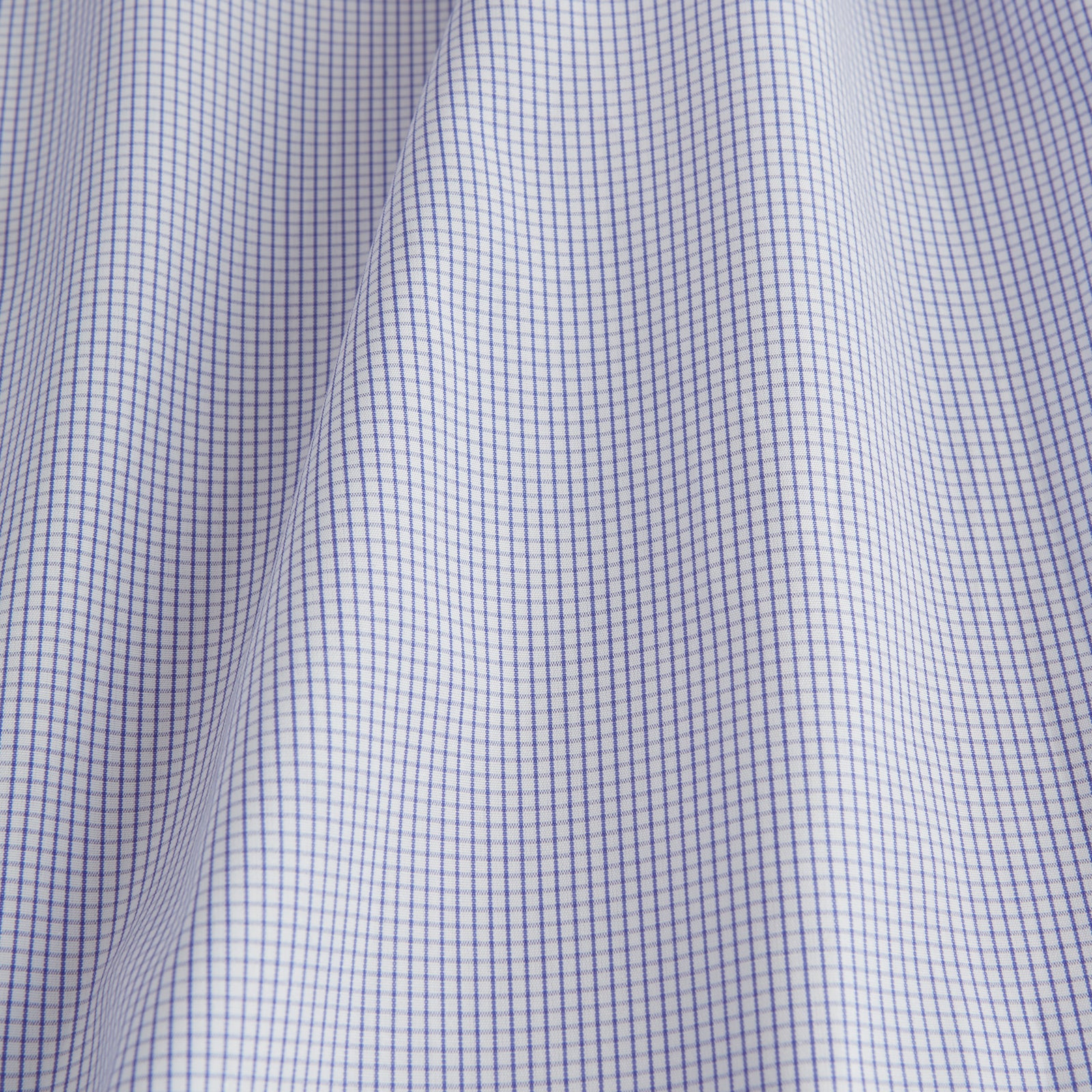 View 4 of product The Blue Grid Check Shirt by Turnbull & Asser features a T&A collar and double cuffs. This cotton long-sleeve shirt has an ultra-fine blue and white grid pattern and is displayed flat on a white background.