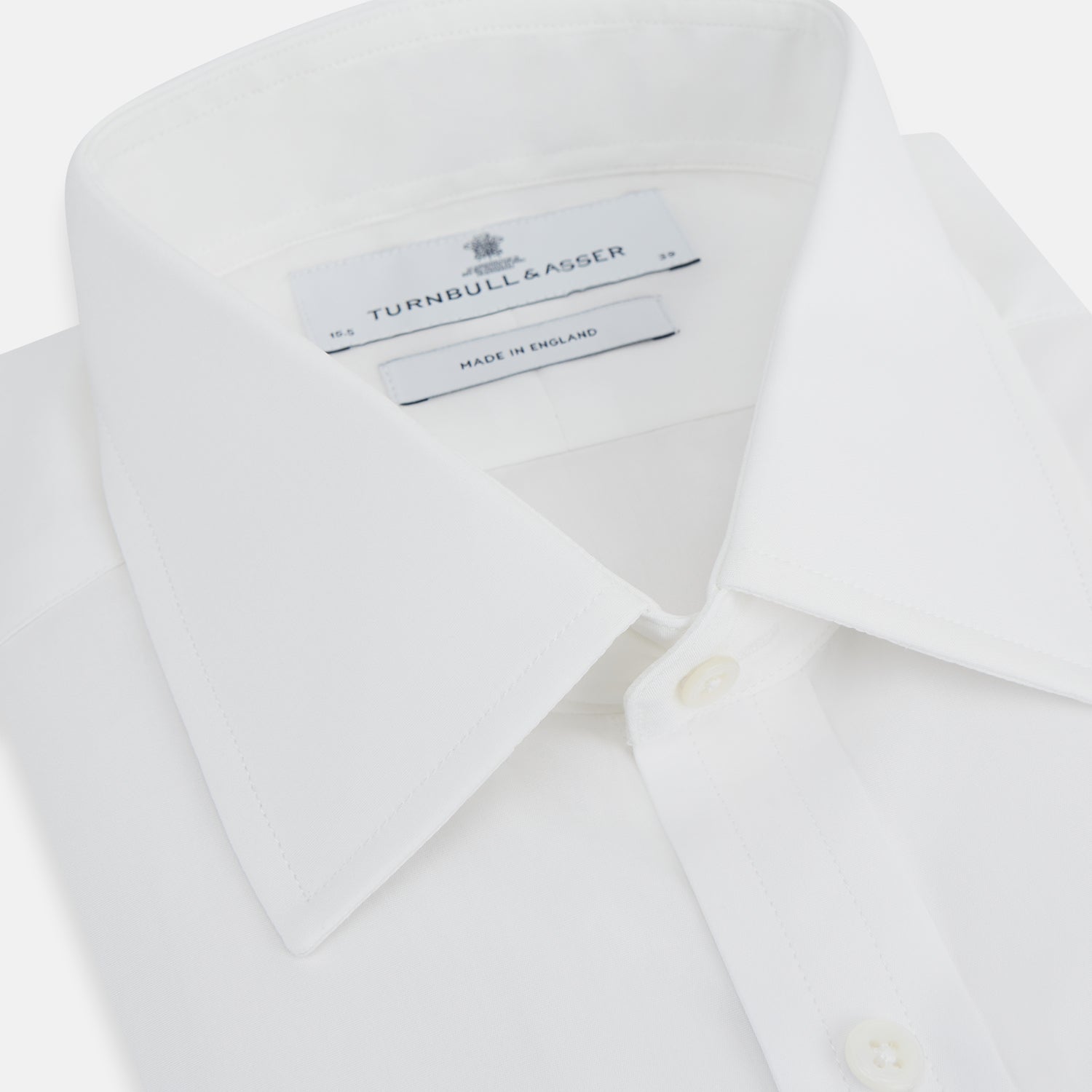 View 2 of product The Turnbull & Asser Plain White Cotton Shirt features a T&A collar, double cuffs, and a straight hem—ideal for minimalist style. Displayed on a plain white background.