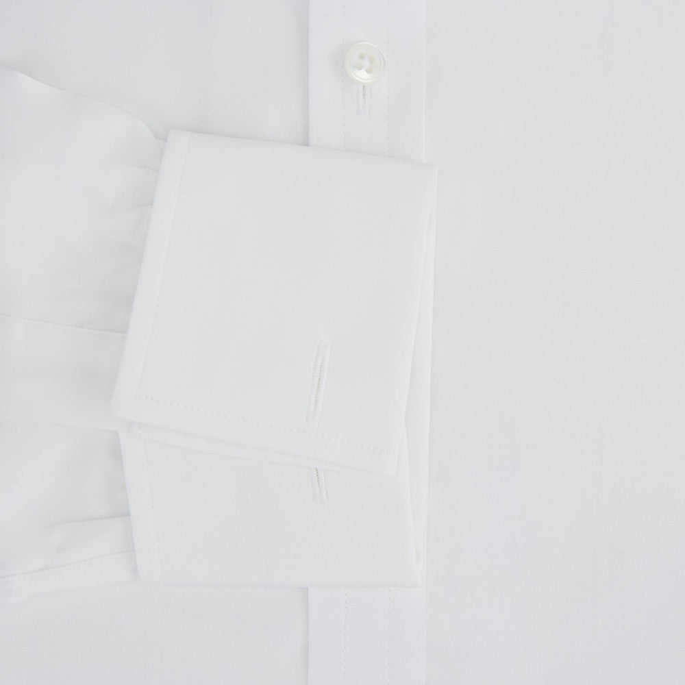 The Turnbull & Asser Plain White Cotton Shirt features a T&A collar, double cuffs, and a straight hem—ideal for minimalist style. Displayed on a plain white background.