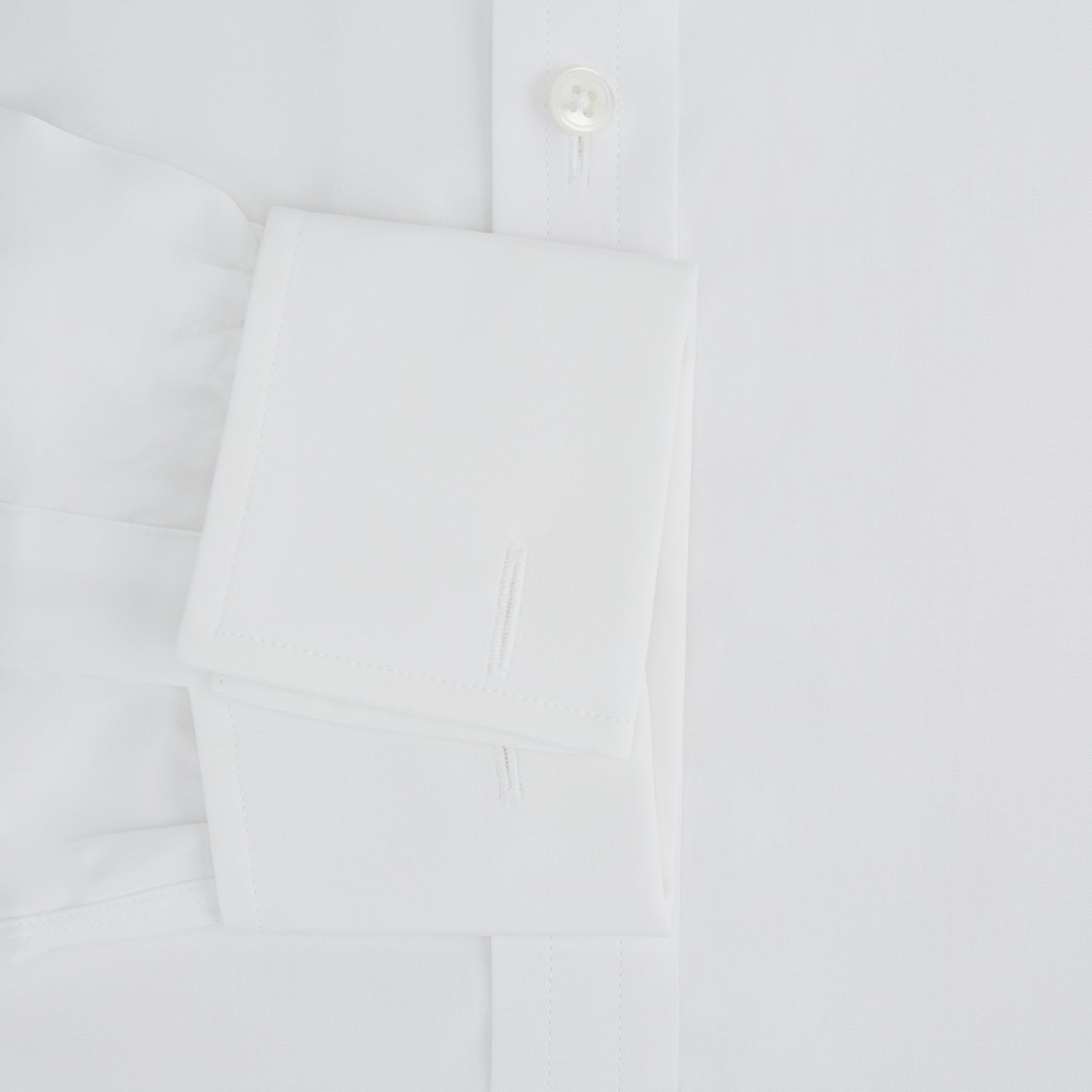 View 3 of product The Turnbull & Asser Plain White Cotton Shirt features a T&A collar, double cuffs, and a straight hem—ideal for minimalist style. Displayed on a plain white background.