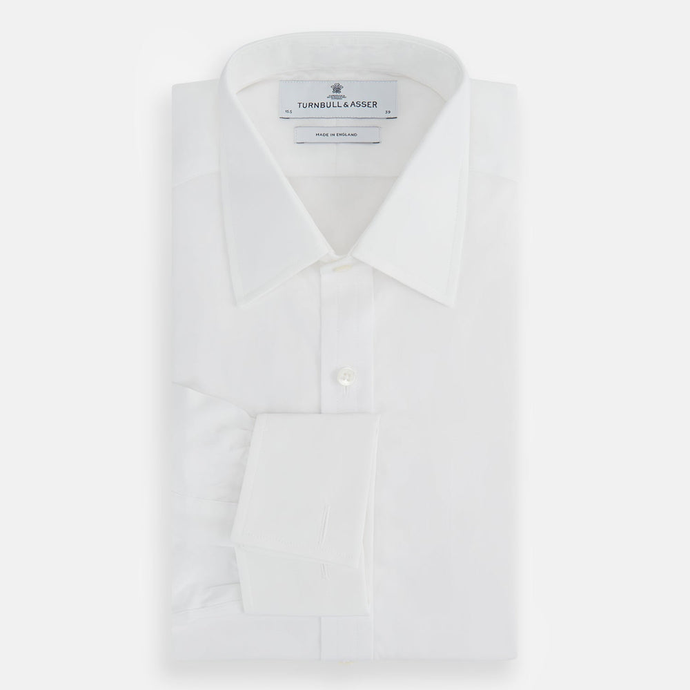 The Turnbull & Asser Plain White Cotton Shirt features a T&A collar, double cuffs, and a straight hem—ideal for minimalist style. Displayed on a plain white background.