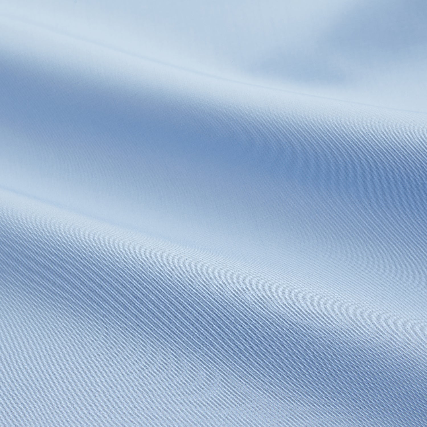 View 4 of product The Turnbull & Asser Pale Blue Organic Cotton Regular Fit Mayfair Shirt features long sleeves, a pointed collar, white buttons, and buttoned cuffs, shown laid flat on a white background.