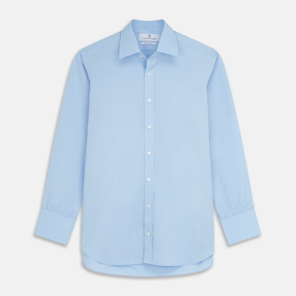 The Turnbull & Asser Pale Blue Organic Cotton Regular Fit Mayfair Shirt features long sleeves, a pointed collar, white buttons, and buttoned cuffs, shown laid flat on a white background.