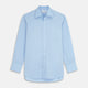 The Turnbull & Asser Pale Blue Organic Cotton Regular Fit Mayfair Shirt features long sleeves, a pointed collar, white buttons, and buttoned cuffs, shown laid flat on a white background.