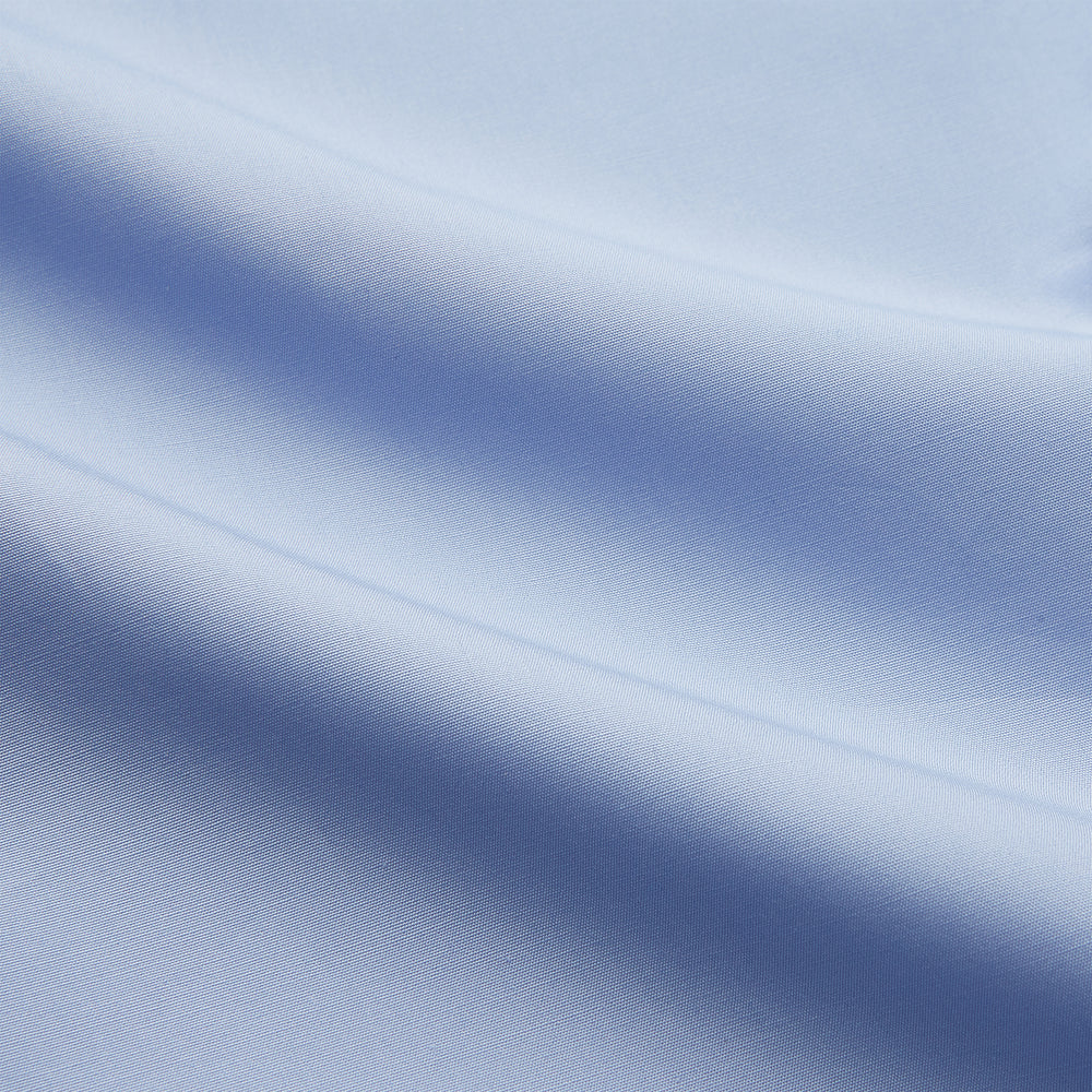 The Turnbull & Asser Tailored Fit Blue Cotton Shirt features a Kent collar and double cuffs, laid flat on a white background—ideal for pairing with a navy suit or any smart look.