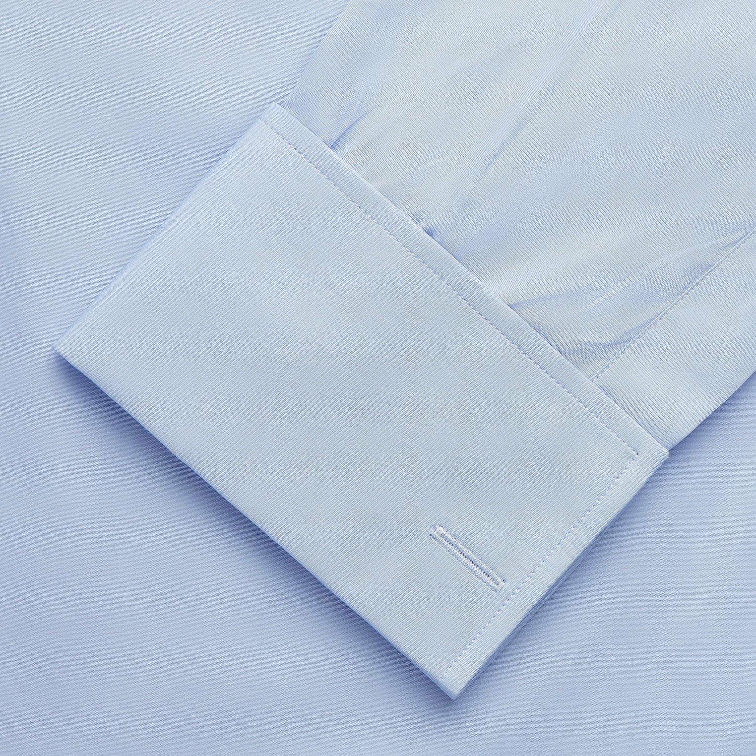 View 3 of product The Turnbull & Asser Tailored Fit Blue Cotton Shirt features a Kent collar and double cuffs, laid flat on a white background—ideal for pairing with a navy suit or any smart look.