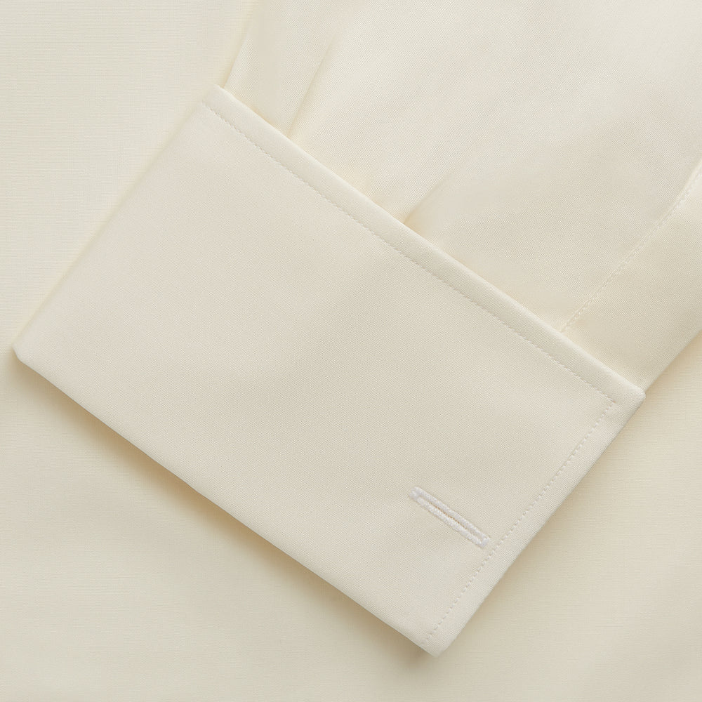 The Turnbull & Asser Tailored Fit Cream Cotton Shirt features a Kent collar and double cuffs, shown laid flat against a white background—ideal for pairing with statement ties.