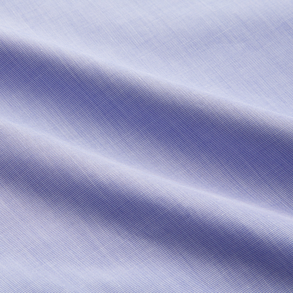 The Turnbull & Asser Tailored Fit Blue End-on-End Cotton Shirt features a Kent collar and double cuffs—ideal for pairing with a navy suit for a sharp look. Laid flat on a white background.
