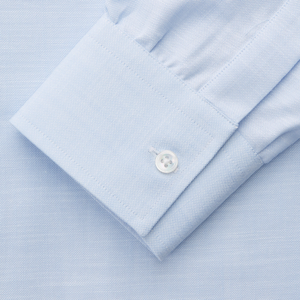 The Turnbull & Asser Plain Blue Weekend Fit Chambray Finch Shirt features a Derby collar, long sleeves, and a front chest pocket—shown laid flat on white—ideal for casual weekend wear.