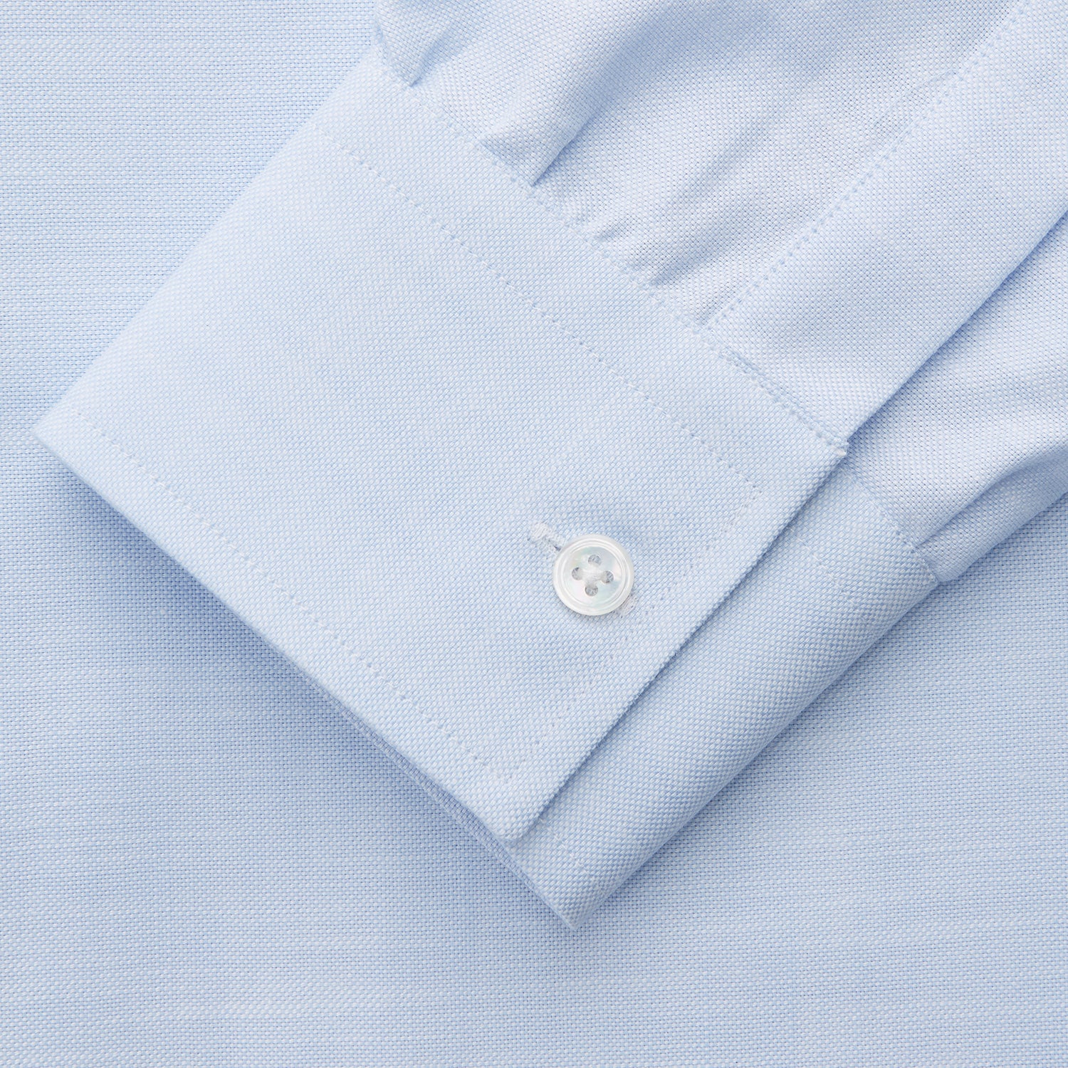 View 3 of product The Turnbull & Asser Plain Blue Weekend Fit Chambray Finch Shirt features a Derby collar, long sleeves, and a front chest pocket—shown laid flat on white—ideal for casual weekend wear.
