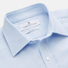 View 2 of product The Turnbull & Asser Plain Blue Weekend Fit Chambray Finch Shirt features a Derby collar, long sleeves, and a front chest pocket—shown laid flat on white—ideal for casual weekend wear.