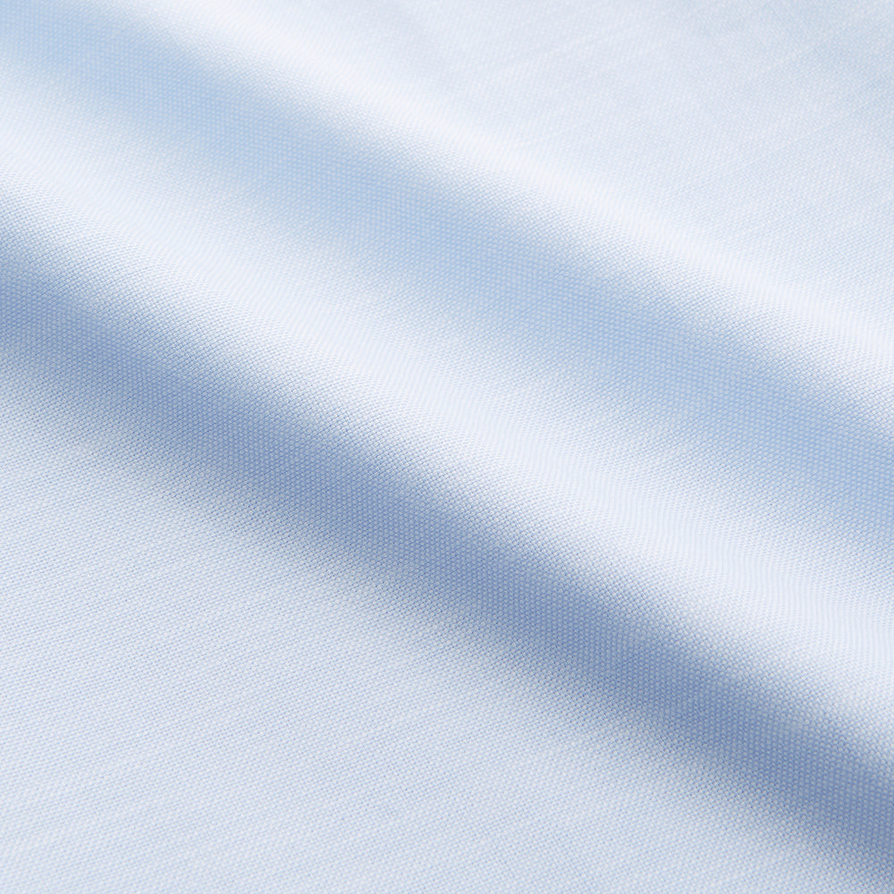 The Turnbull & Asser Plain Blue Weekend Fit Chambray Finch Shirt features a Derby collar, long sleeves, and a front chest pocket—shown laid flat on white—ideal for casual weekend wear.