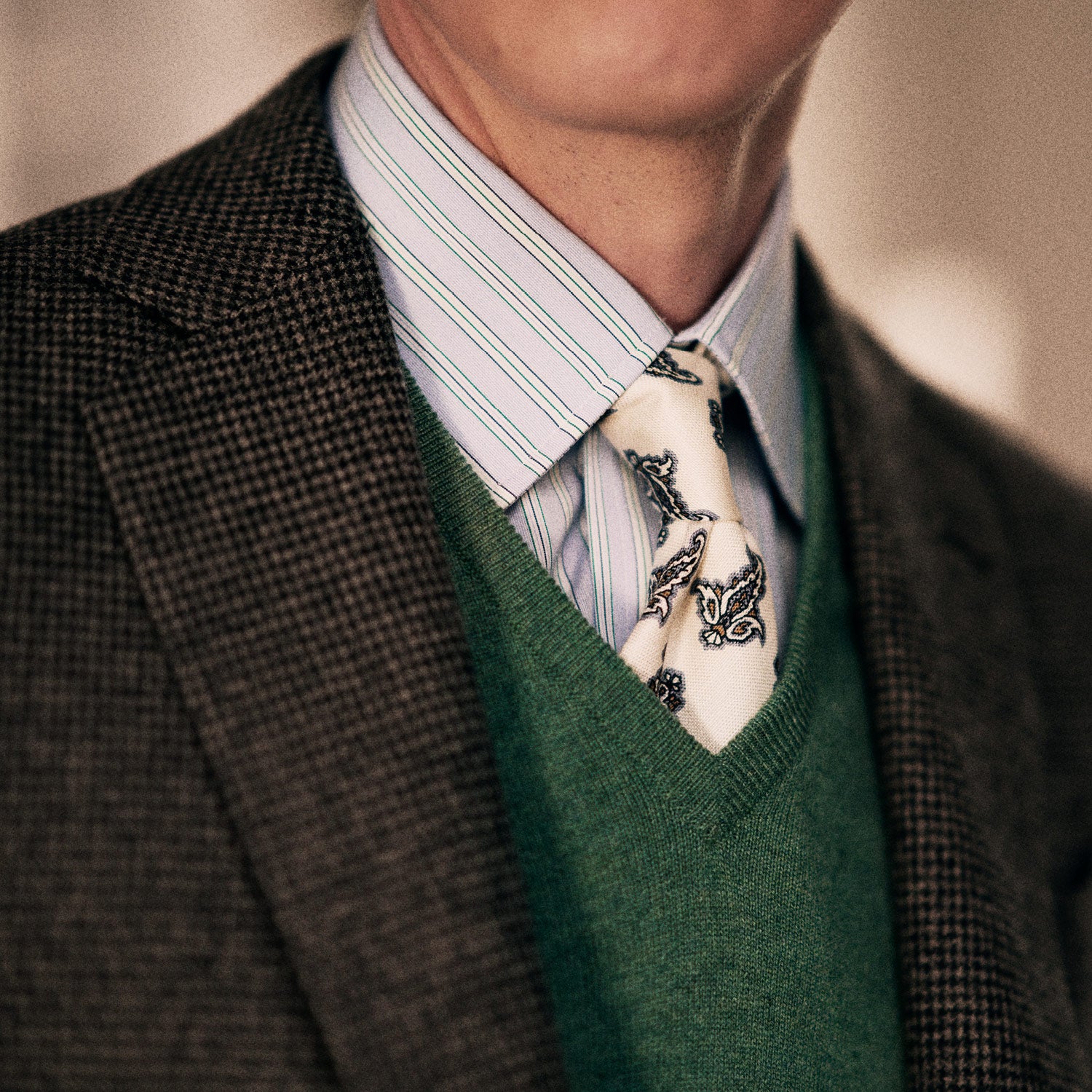 View 2 of product The Ecru Paisley Floral Cotton Silk Blend Tie by Turnbull & Asser features a paisley floral pattern, elegantly displayed and neatly rolled on a plain white background.