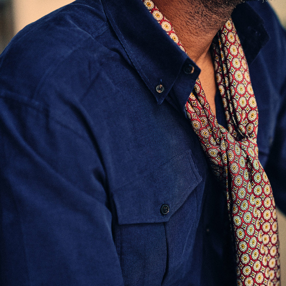The Turnbull & Asser Midnight Blue Corduroy Officer Weekend Fit Shirt features a soft Dorset collar, relaxed fit, 1-button cuffs, and two button-flap chest pockets, shown on a white background.