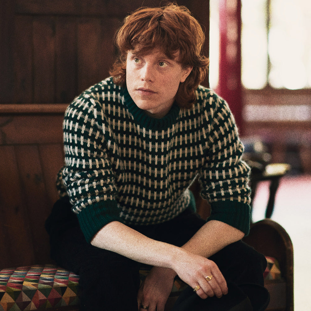 The Holly Green Knitted Cashmere Crewneck Jumper by Turnbull & Asser features a ribbed neckline, cuffs, and hem—a timeless investment piece for fans of signature knits.