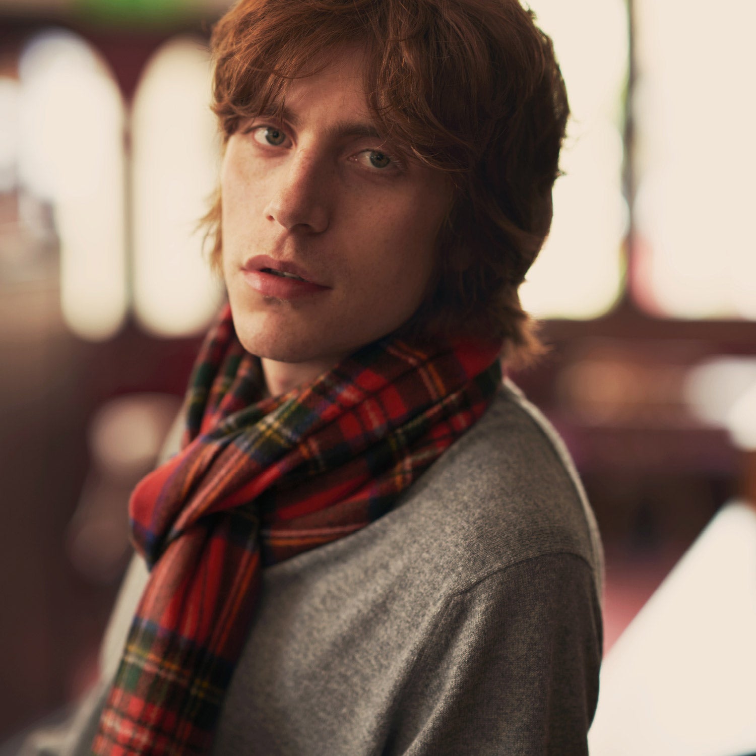 View 2 of product The Turnbull & Asser Royal Stewart Tartan Cashmere Scarf, showcasing a classic red plaid with black, yellow, and green accents and fringed ends, is displayed against a white background.