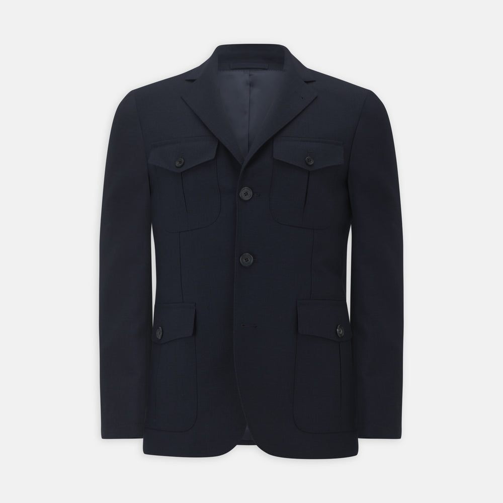 The Turnbull & Asser Navy Lightweight Wool Hopsack Traveller Jacket features a notched lapel, three front buttons, and four flap pockets—two on the chest and two at the waist—all displayed on a plain white background.
