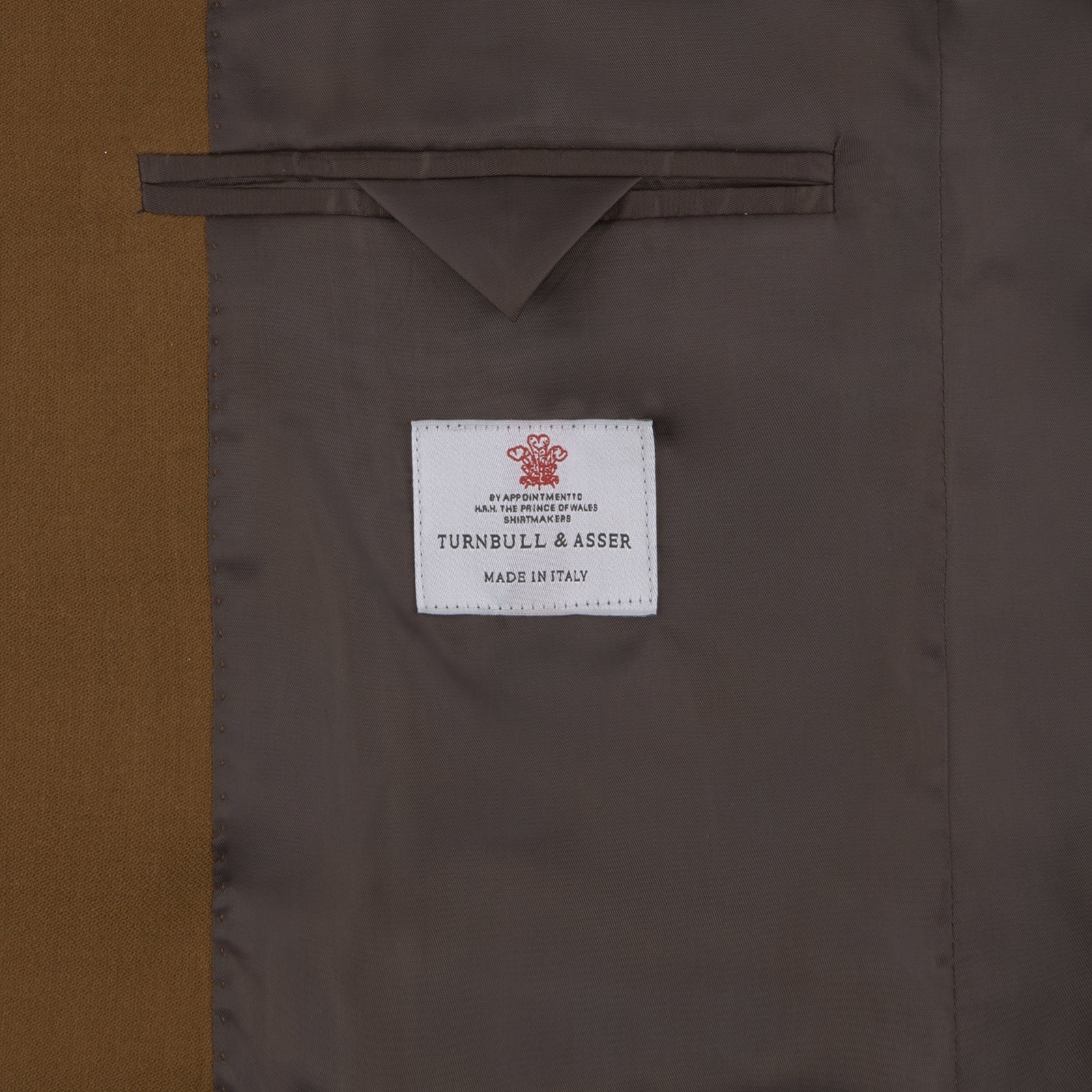 View 4 of product The Turnbull & Asser Tobacco Plainweave Cashmere Jacket is a single-breasted brown summer jacket with two buttons, notch lapels, and flap pockets, tailored in Italy and shown on a plain white background.