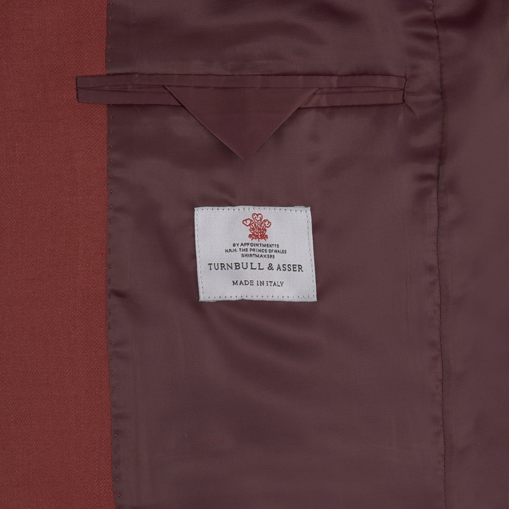 The Turnbull & Asser BLZ065-GGAY02 BARRINGTON blazer in red (WO/SI/LI blend) features a single-breasted design, notch lapels, one-button closure, and three front pockets, shown against a plain white background.