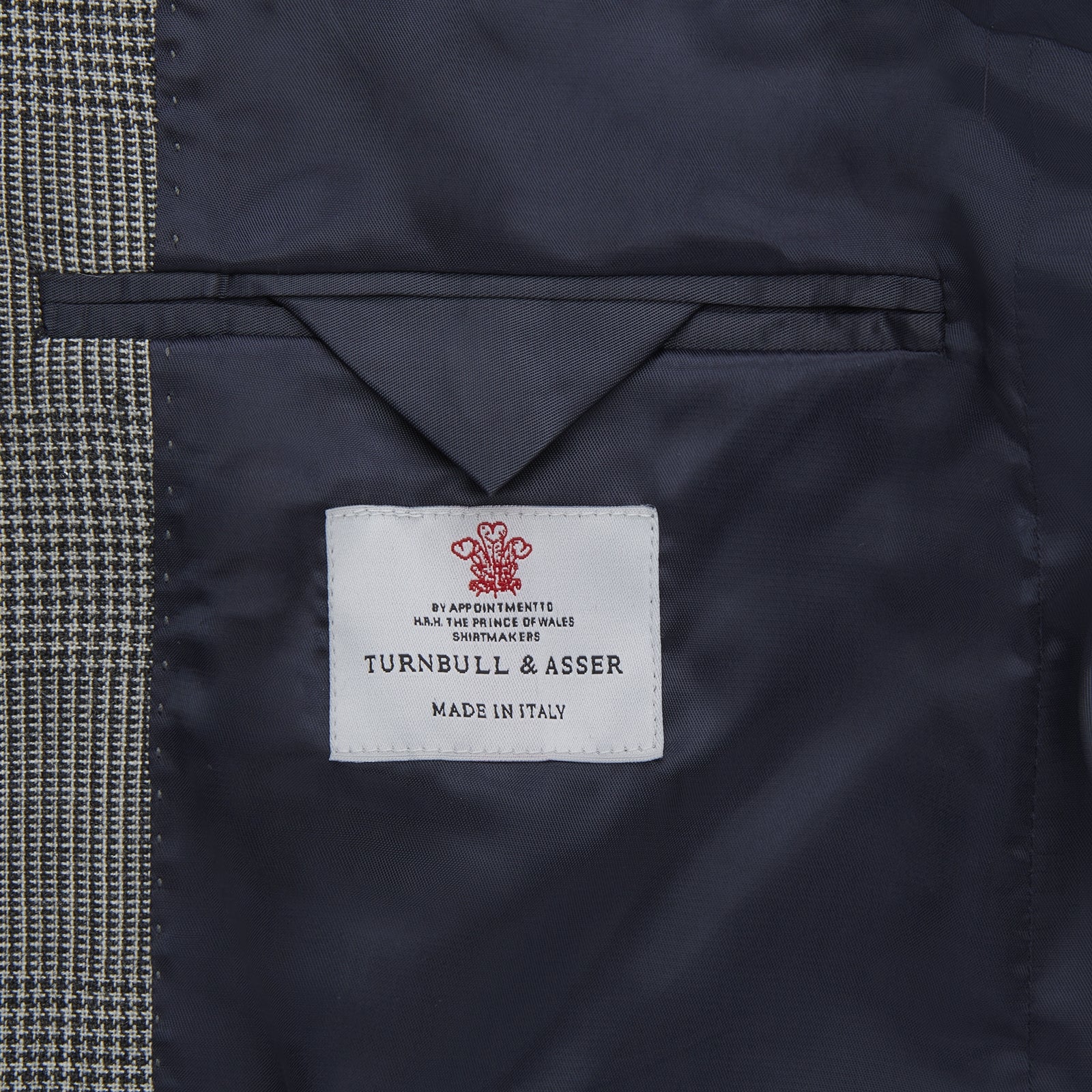 View 2 of product The Turnbull & Asser Grey Prince of Wales Check Wool Hopsack Jacket features a notched lapel, two-button closure, two front flap pockets, and a chest pocket, shown on a plain white background.