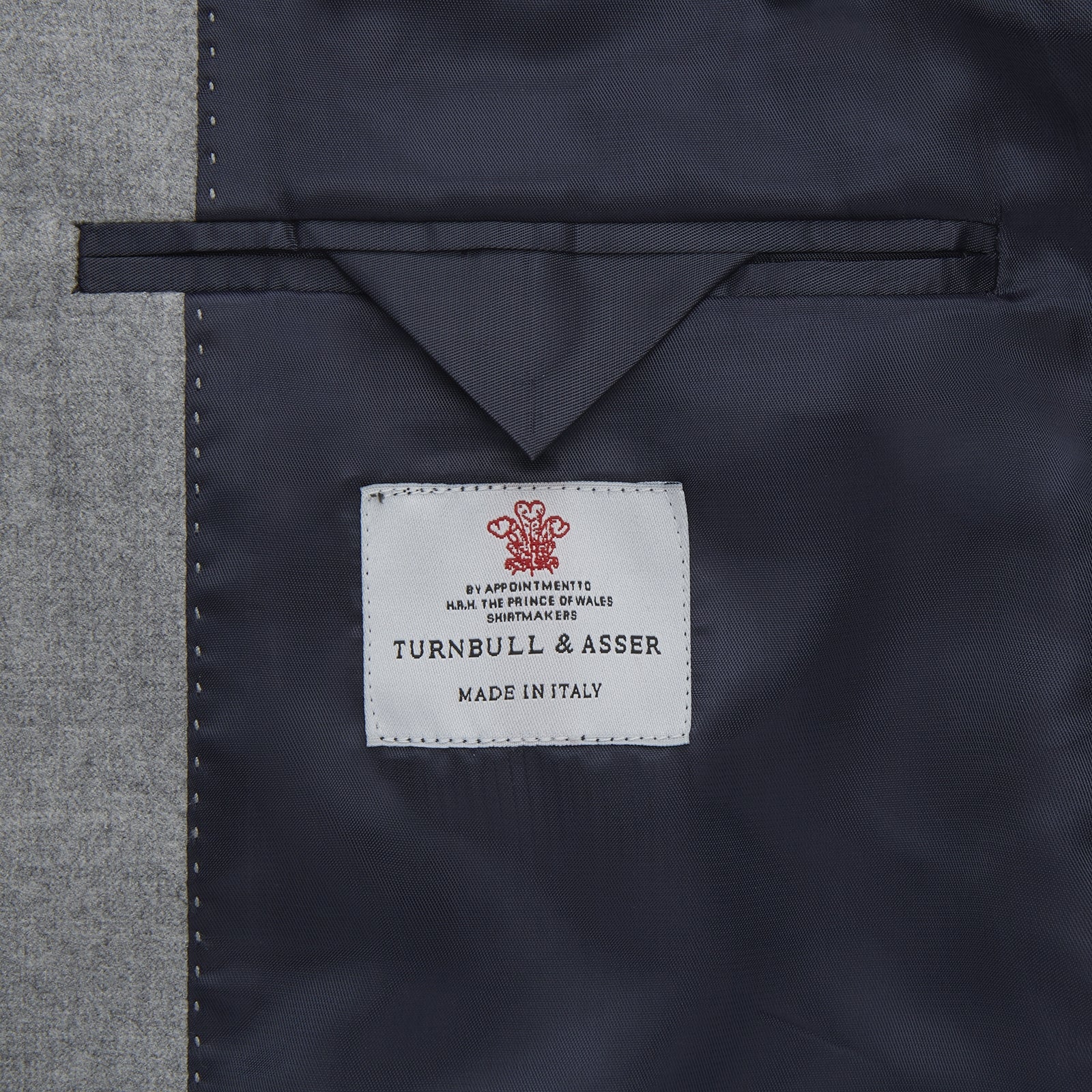 View 2 of product The Dove Grey Escorial Lightweight Wool Jacket by Turnbull & Asser features soft Escorial wool, a notched lapel, two front buttons, three pockets, and a single chest pocket, shown against a plain white background.