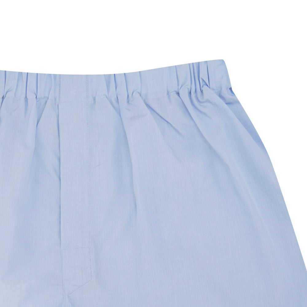 Turnbull & Asser Light Blue End-On-End Cotton Boxer Shorts feature an elastic waistband for everyday comfort and style, shown here laid flat on a white background.