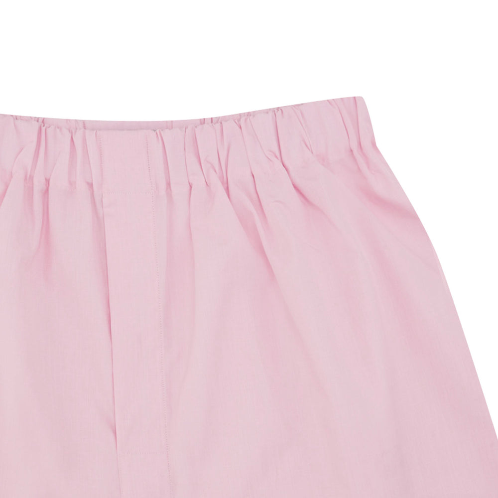 The Turnbull & Asser Pink End-On-End Cotton Boxer Shorts feature a light pink hue, elasticated waistband, and relaxed fit, shown against a plain white background.