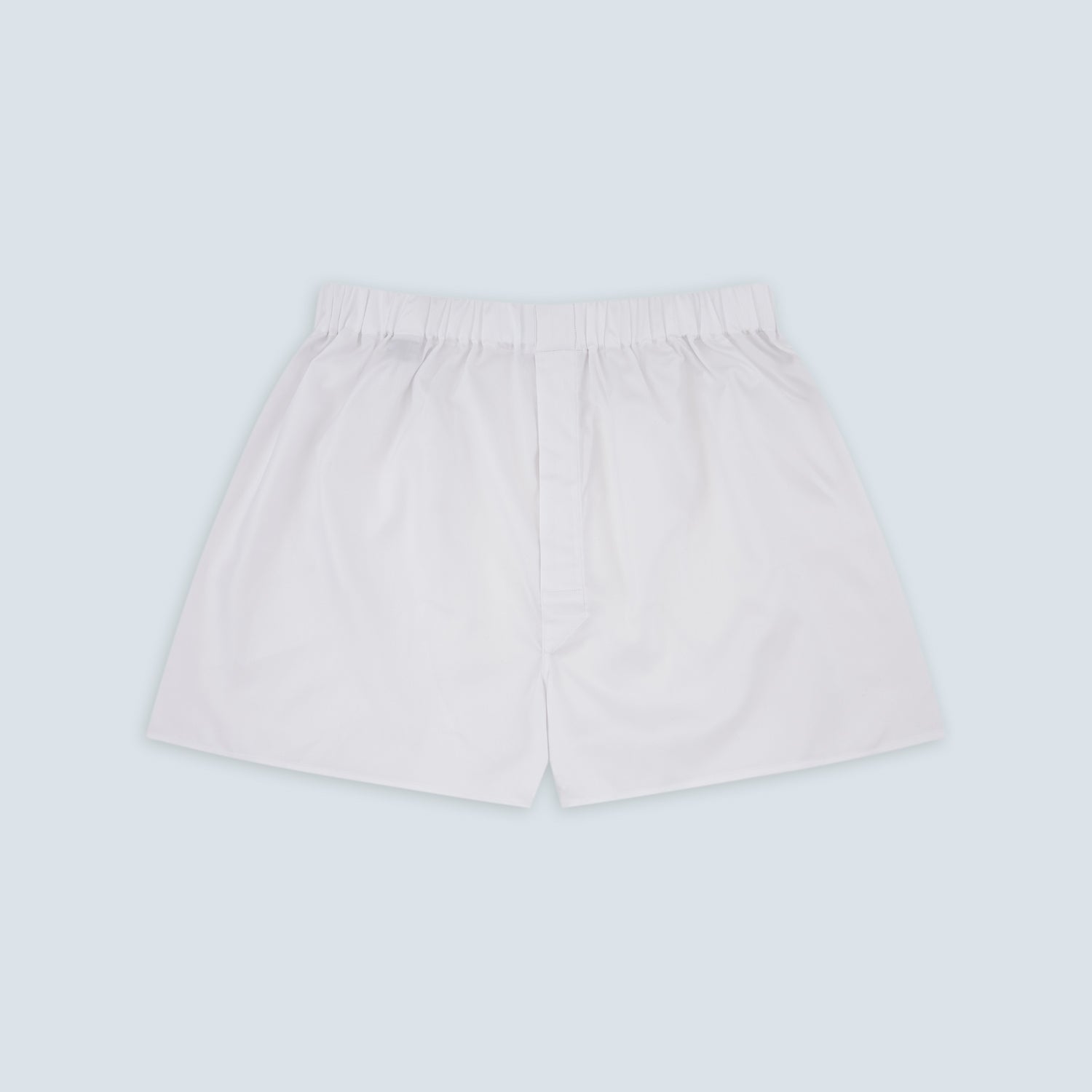 View 1 of product Turnbull & Asser White Sea Island Quality Cotton Twill Boxer Shorts feature an elastic waistband and are photographed laid flat on a light blue background for a luxurious touch.