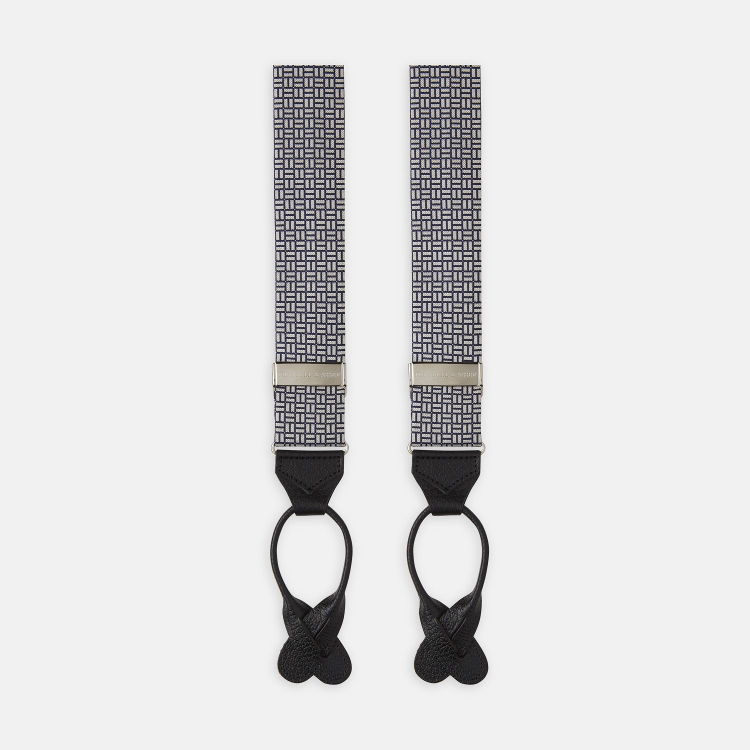 View 1 of product Turnbull & Asser’s Silver and Charcoal Geometric Adjustable Silk Braces feature a black and white geometric pattern, black leather looped ends, and metal hardware, echoing classic refinement against a plain white background.
