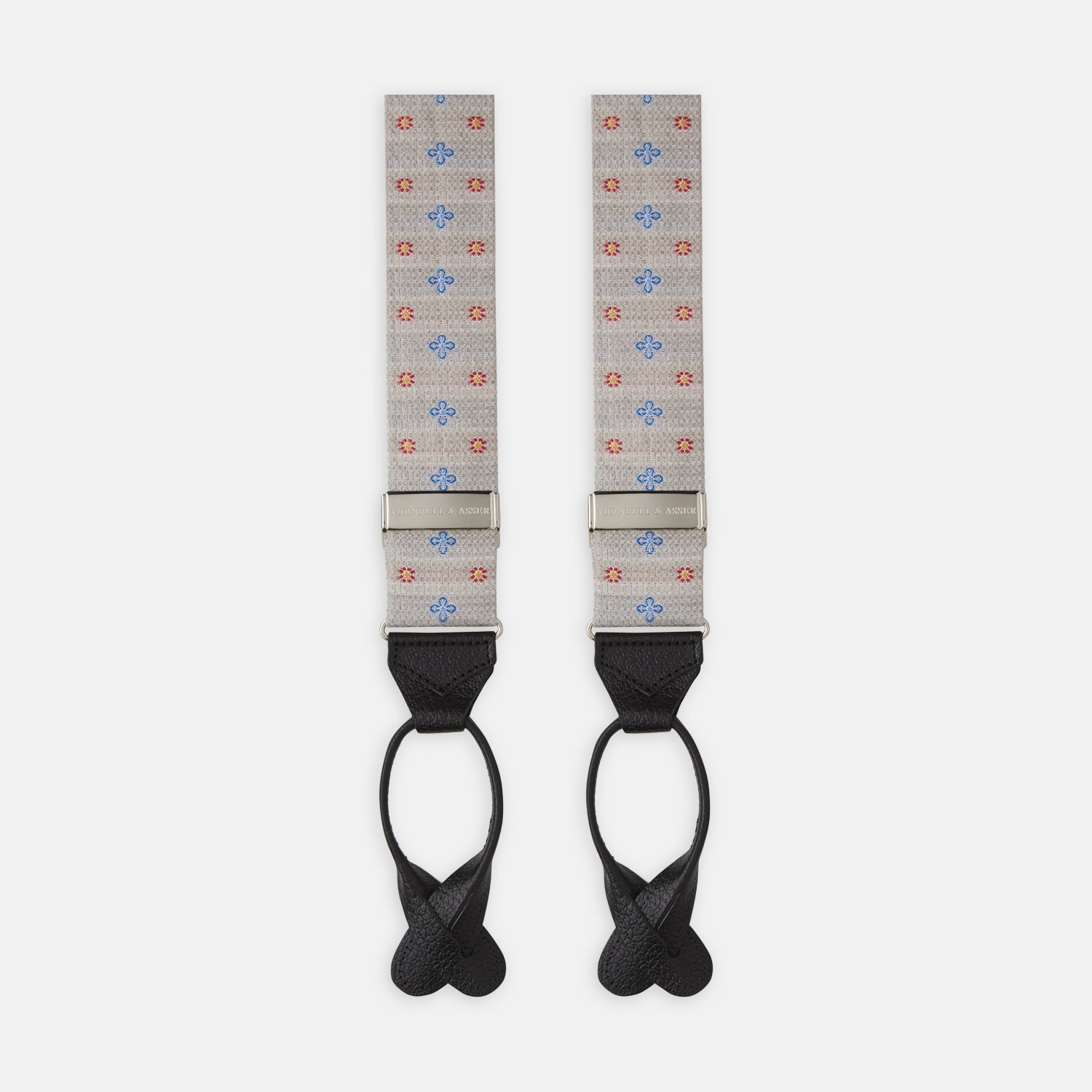 View 1 of product Turnbull & Asser’s Dove Grey Floral Silk and Linen Adjustable Braces feature blue and red flowers, black leather ends, and silver adjusters—an elegant choice to add flair to your summer suit.