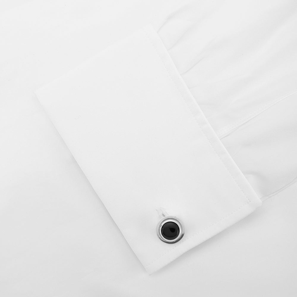 Turnbull & Asser’s Reversible Monochrome Sterling Silver Round Cufflinks feature elegant edges with one white mother-of-pearl center and the other a black onyx center, shown on a plain light gray background.