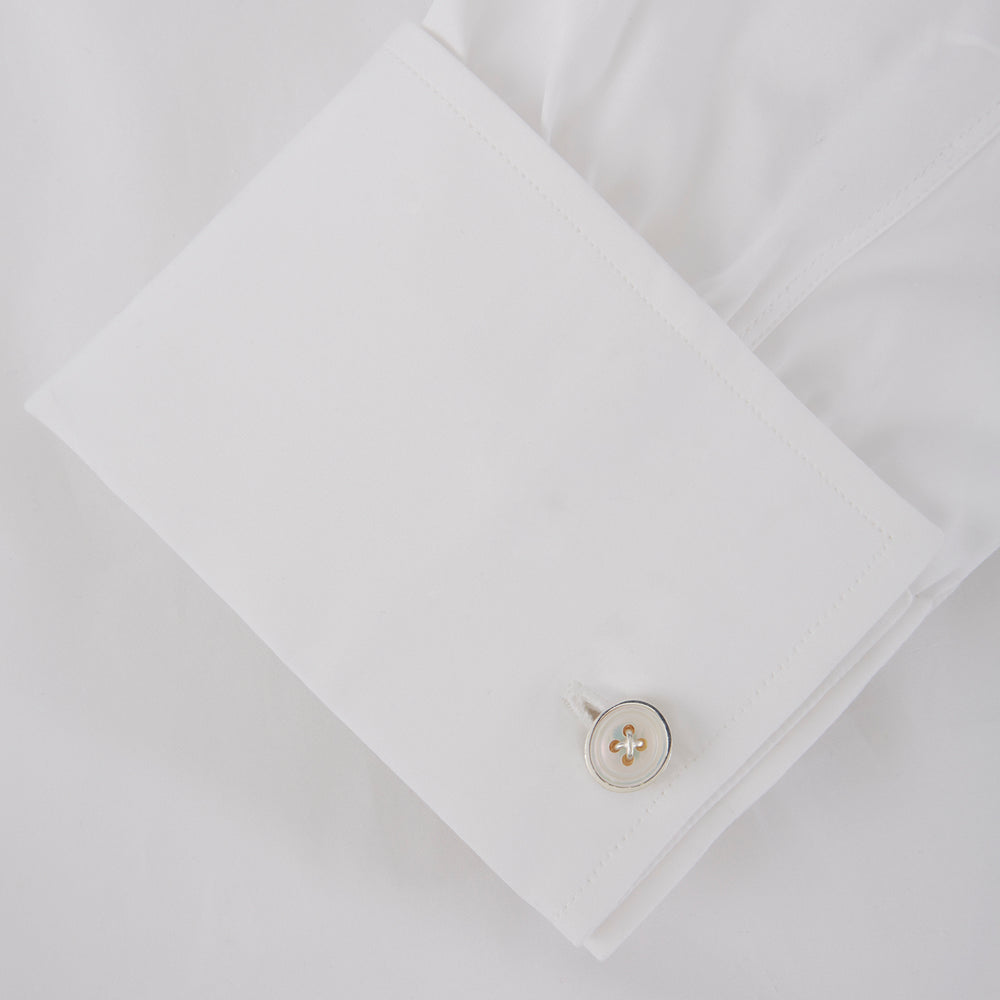 Turnbull & Asser’s Reversible Sterling Silver Mother-of-Pearl Button Cufflinks feature a round button design with four central holes, showcasing a dark iridescent face on one side and a light mother-of-pearl face on the other.