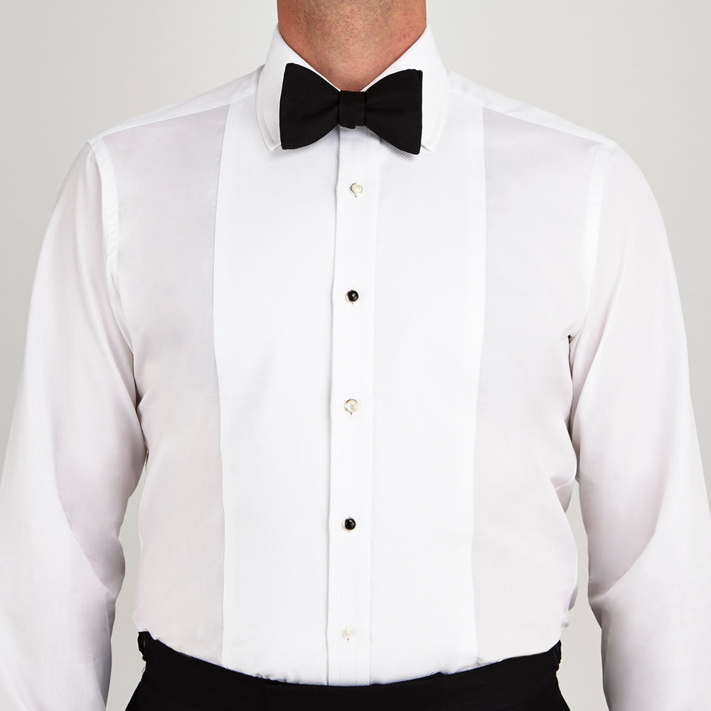 Turnbull & Asser Reversible Sterling Silver Dress Studs feature round faces with black onyx on one side and white mother-of-pearl on the other, set against a simple light gray background.