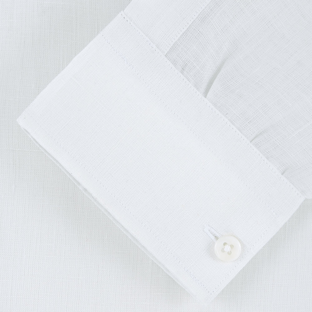 The Weekend Fit Cream Linen Shirt by Turnbull & Asser features a stand collar, button front, and 1-button cuff. Displayed neatly folded, the cream linen shirt highlights its refined craftsmanship against a light grey background.