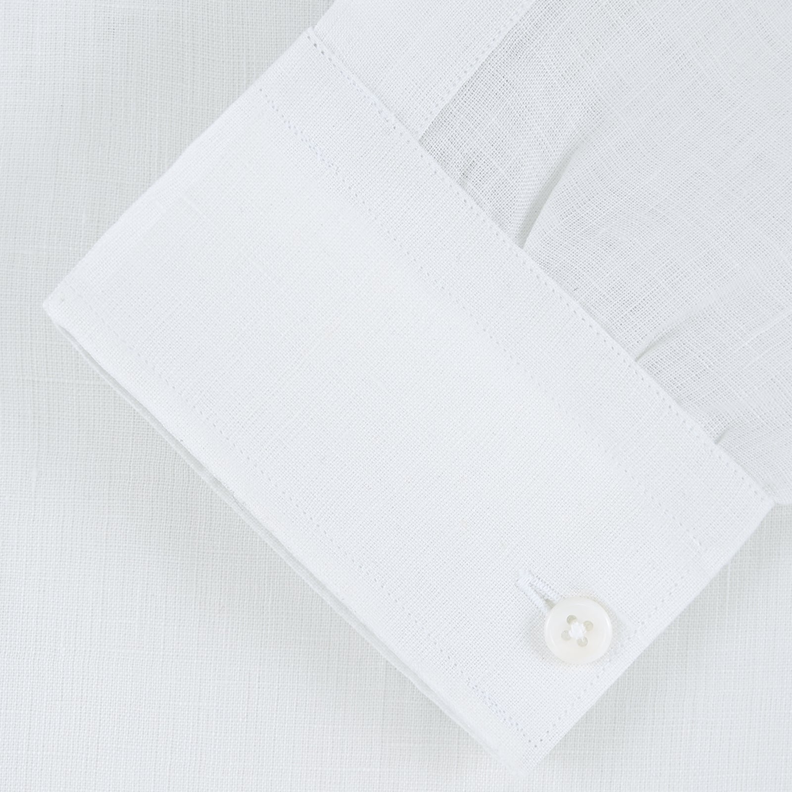 View 2 of product The Weekend Fit Cream Linen Shirt by Turnbull & Asser features a stand collar, button front, and 1-button cuff. Displayed neatly folded, the cream linen shirt highlights its refined craftsmanship against a light grey background.