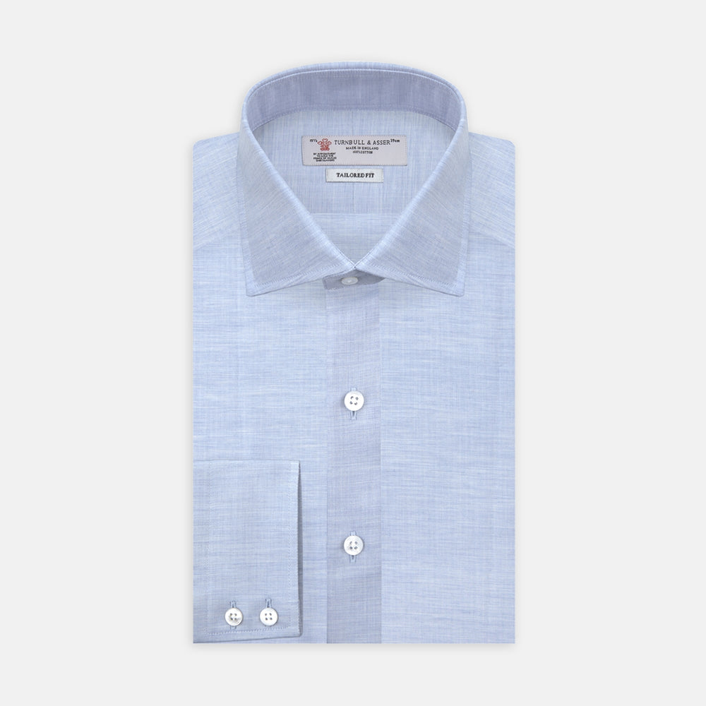The Turnbull & Asser Esquire Edit Tailored Fit Light Blue Shirt features a Kent collar and 2-button cuffs, neatly folded and displayed on a plain light gray background.