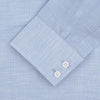 View 3 of product The Turnbull & Asser Esquire Edit Tailored Fit Light Blue Shirt features a Kent collar and 2-button cuffs, neatly folded and displayed on a plain light gray background.