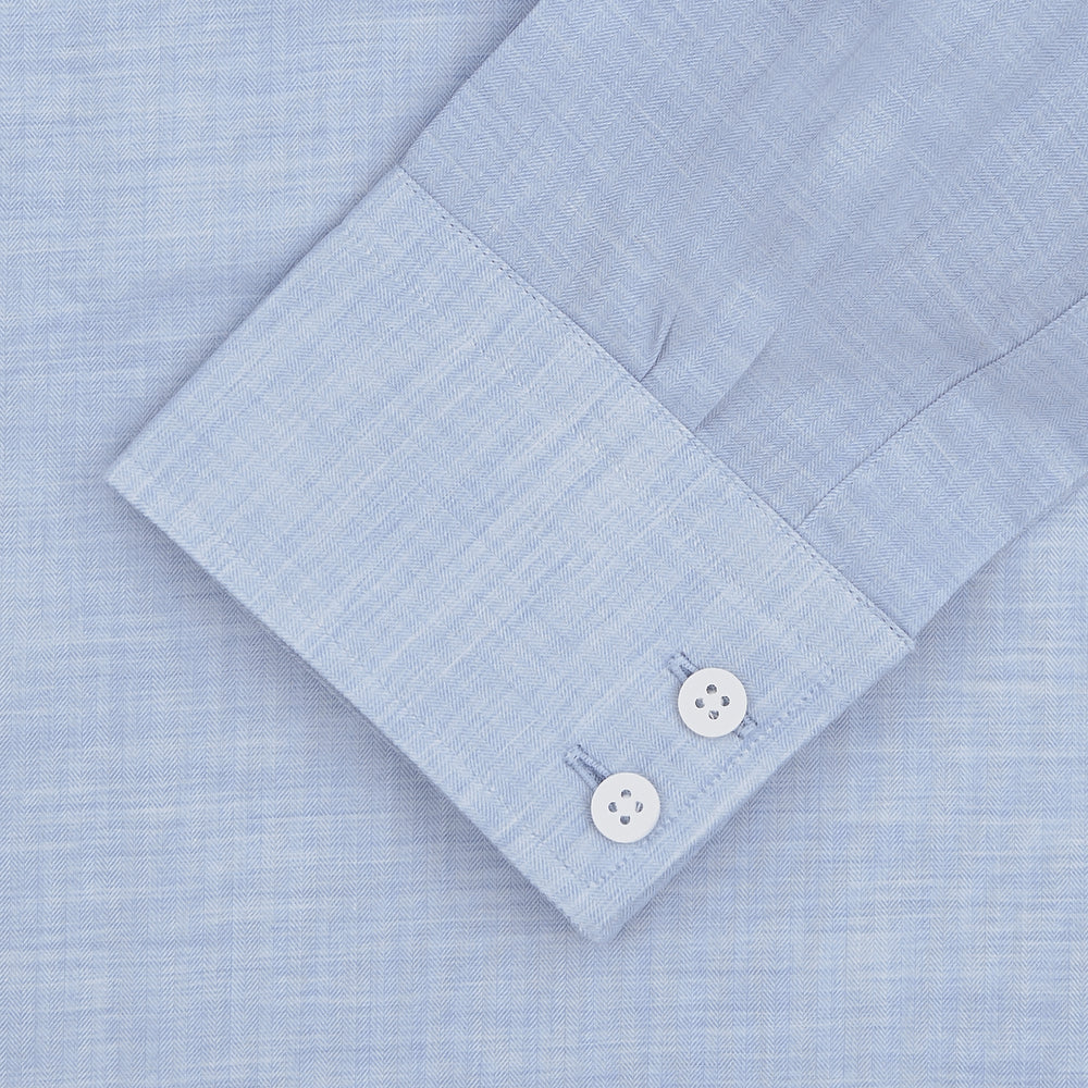 The Turnbull & Asser Esquire Edit Tailored Fit Light Blue Shirt features a Kent collar and 2-button cuffs, neatly folded and displayed on a plain light gray background.