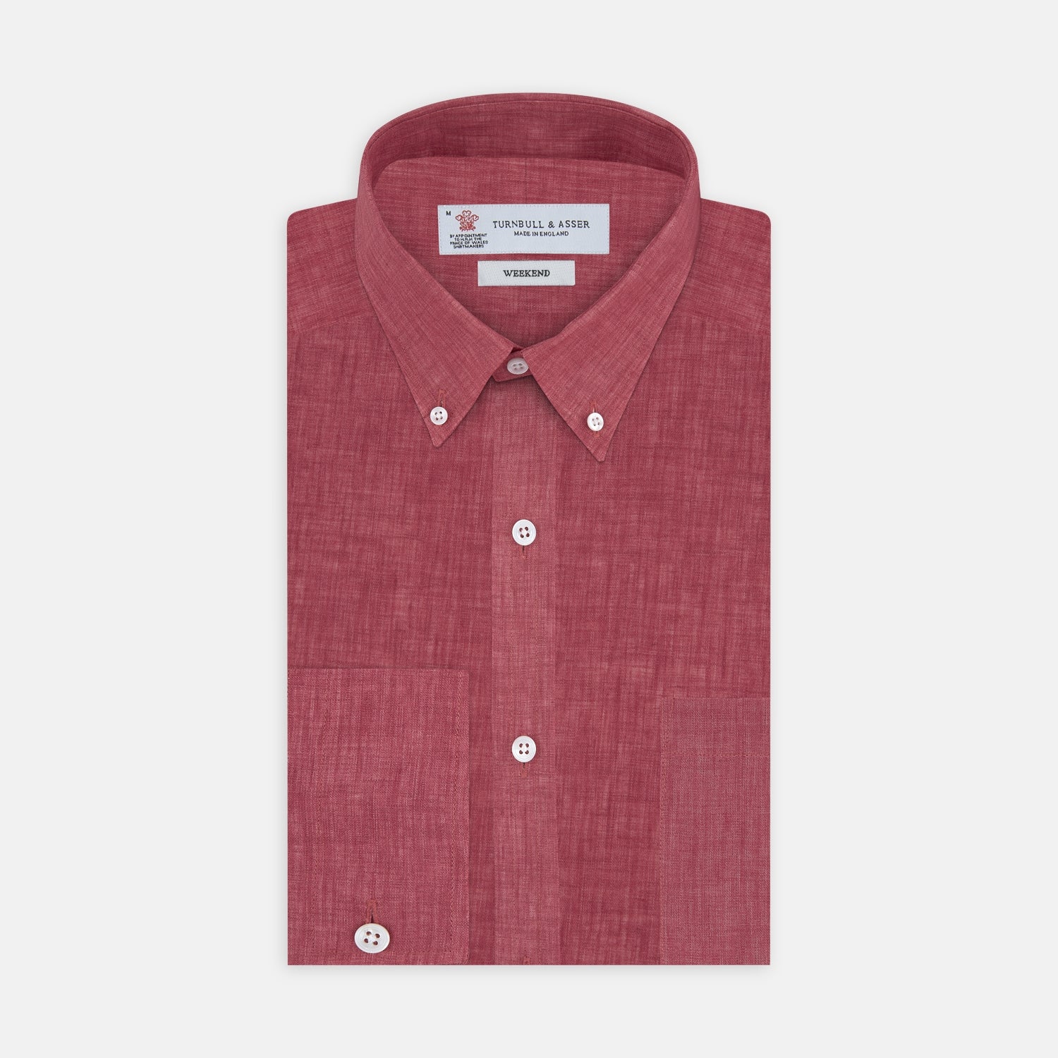 View 1 of product The Turnbull & Asser Weekend Fit Red Linen Shirt features a Dorset collar, 1-button cuff, white buttons, and patch pocket. The long-sleeve shirt is neatly folded and displayed on a plain white background.