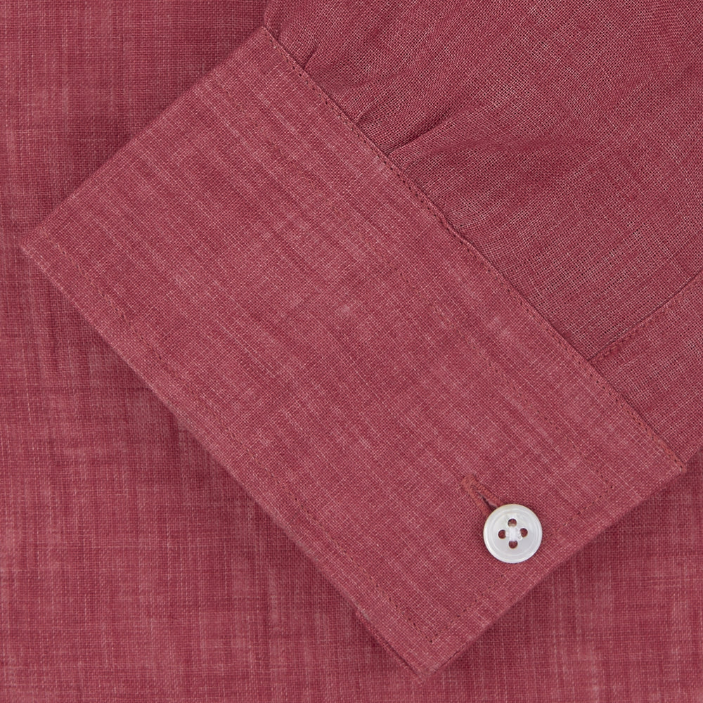 The Turnbull & Asser Weekend Fit Red Linen Shirt features a Dorset collar, 1-button cuff, white buttons, and patch pocket. The long-sleeve shirt is neatly folded and displayed on a plain white background.