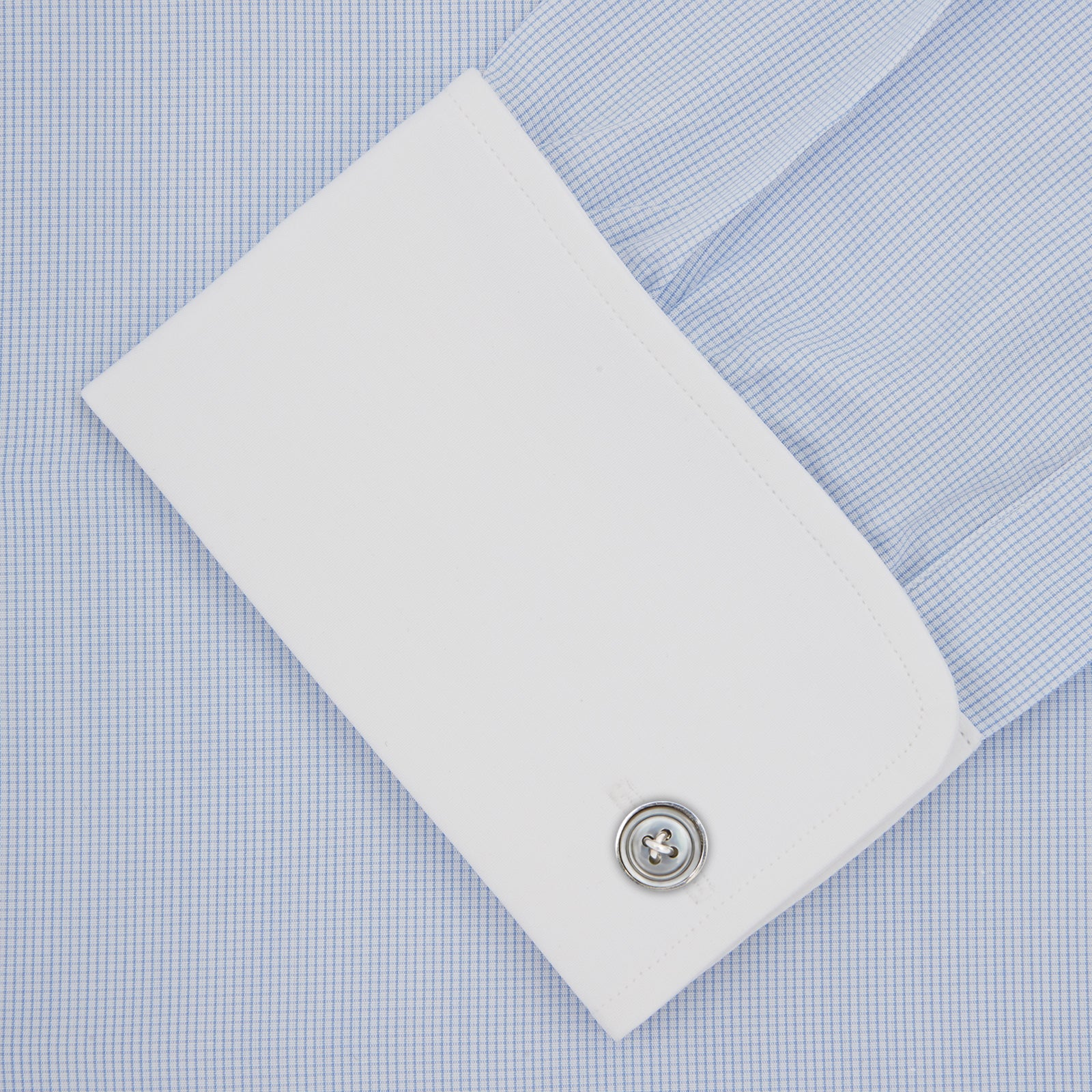 View 6 of product A neatly folded The Great Gatsby Cotton Shirt by Turnbull & Asser, featuring a light blue body, white rounded collar, and double cuffs inspired by 1920s style, displayed on a plain light background.