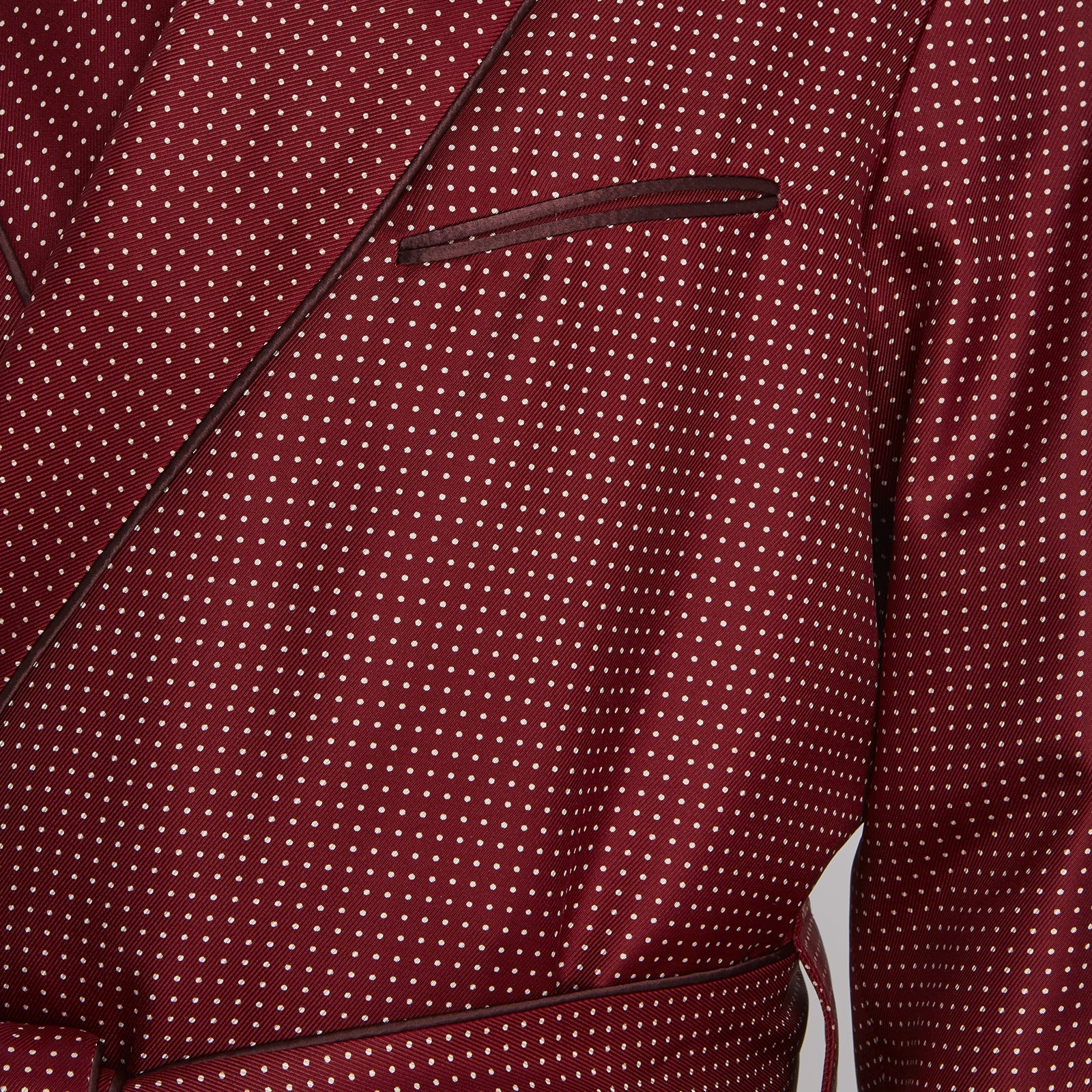 View 5 of product The Turnbull & Asser Burgundy Piped Silk Spot Gown features small white polka dots, a shawl collar, fabric belt, and chest pocket—luxurious nightwear and a stylish men’s statement piece—shown on a white background.