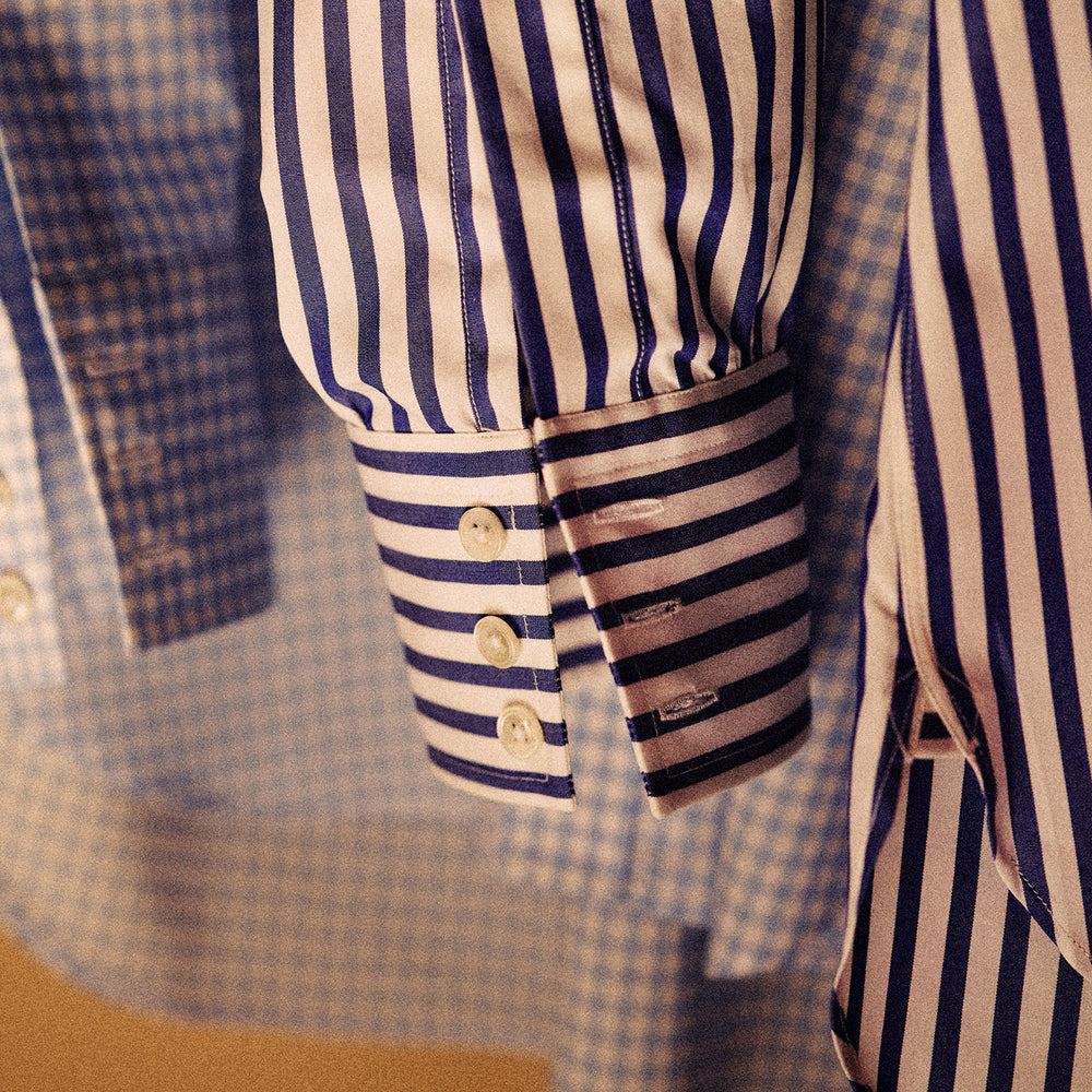 The Turnbull & Asser Blue and White Wide Stripe Shirt features a T&A collar and 3-button cuffs—its bold vertical stripes make it perfect for office wear, shown here on a white background.