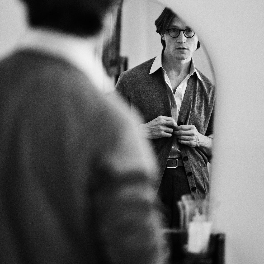 The Grey Fine Cashmere Cardigan by Turnbull & Asser is a long-sleeve, button-up sweater with two front pockets, shown on a white background.